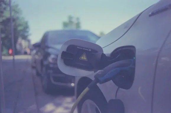 An electric car plugged in and charging