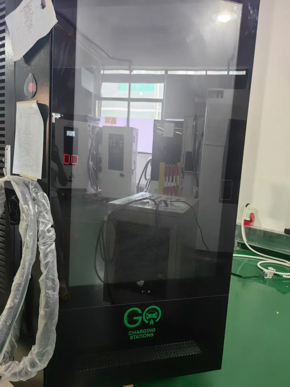 A GO Charging Stations unit with its large display screen, at the factory before delivery